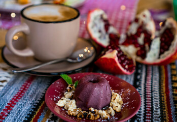 a cup of cocoa, pudding and pomegranate, chocolate puding in the glass with pomegranate.Supangle or pudding