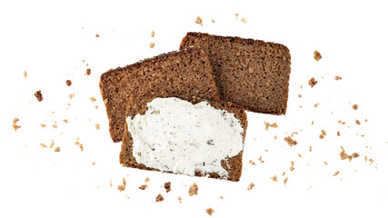 Cutting slices of dark rye cereal bread with crumbs flying isolated on white background.