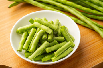 Sliced yardlong bean on white plate background