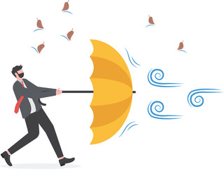 Businessman holding umbrella in protection for strong wind. survive crisis situation concept

