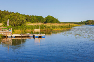 Fototapeta na wymiar Beautiful view of the lake with a boat dock and a pier for swimming. Sweden.