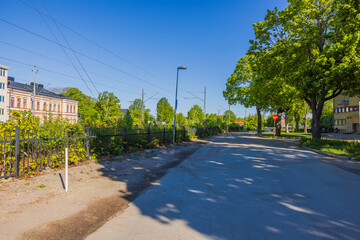 Beautiful view of street green trees, a divider along the railway tracks, and residential houses....