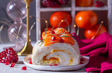 Meringue roll filled with mascarpone, cream and tangerine jam, decorated with tangerines and pomegranate seeds. - 729504699