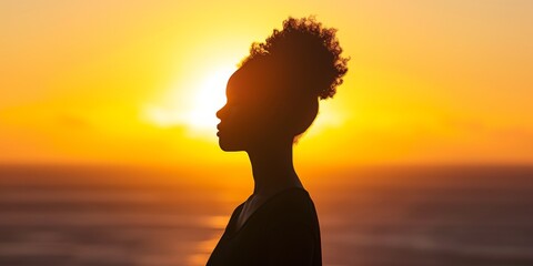 Silhouette Of An African American Woman Captures The Essence Of Hope And Liberation In The Backdrop Of A Sunrise Over The Sea