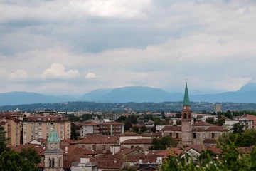 Deurstickers Aerial panoramic view of historic city of Udine, Friuli Venezia Giulia, Italy, Europe. Viewing platform form castle of Udine. Cloudy overcast day. Distant view of mountains of Alps, border to Austria © Chris