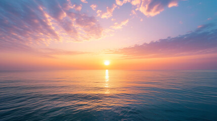 An inspiring sunrise over a calm ocean with soft hues painting the sky and reflecting on the water. - Powered by Adobe
