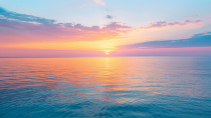 An inspiring sunrise over a calm ocean with soft hues painting the sky and reflecting on the water.