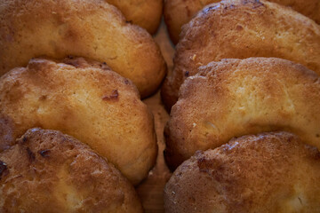 Sochen sweet made from shortcrust pastry with cottage cheese filling. Sweetish Bakery pastry snack. Sochnik - Russian curd cake baked in the oven. Fresh pastries lie in two rows close-up