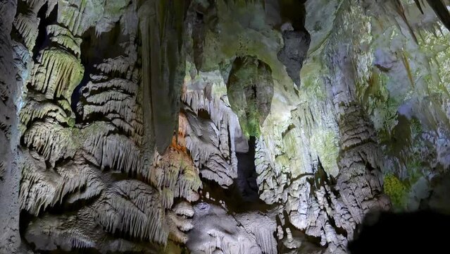Prometheus (Kumistavi) cave near Tskaltubo and Kutaisi. Imereti Region. Natural monument with hanging stone curtains, stalactites and stalagmites, colorful illuminated rock formations.
