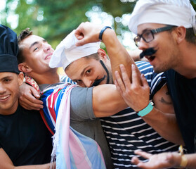 Halloween, party and men friends in a park with chef, costume or holiday celebration. Forest, festival and people in nature for fun, vacation or bonding and an event on weekend, day off or reunion