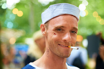 Portrait, smile and man with a cigarette, music festival and sailor outfit with fun and costume....