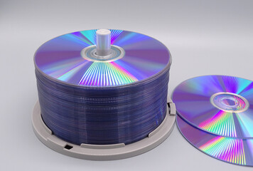  a stack of dvd's in front of a grey background    