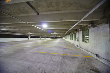 Spacious Empty Parking Garage with Fluorescent Lighting and Green Windows