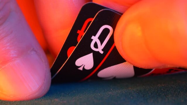 hand holds pair of queens, hearts and spades in a game of texas hold em poker