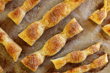 homemade cakes. puff pastry sticks baked with cinnamon and sugar