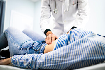 Doctor gastroenterologist palpates patient stomach. Abdominal examination and healthcare.