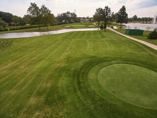 Aerial View of Sunny Golf Course with Pink Ball and Water Hazard