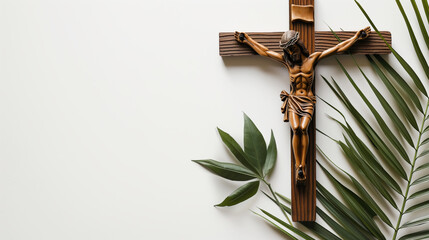 Crucifix with figure of Jesus, red candle and palm leaves on white background