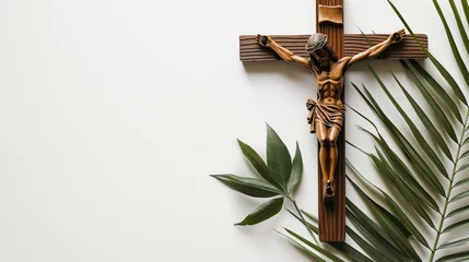 Fotobehang Crucifix with figure of Jesus, red candle and palm leaves on white background © colnihko