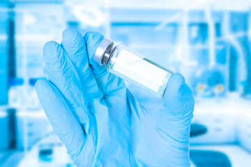 medical vial with a vaccine in the hands of a doctor in medical gloves. Close-up of a hand and a...