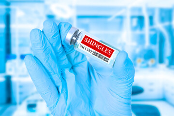 Vaccine, shingles , Medical ampoule of herpes zoster vaccine in the hands of a doctor. Soft blue...