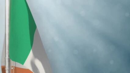 Waving Ireland flag on light blue bokeh bg