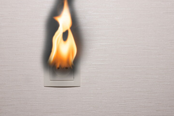 An electrical outlet on the inner wall of a residential building burns and smokes. Electrical short circuit. copy space. - obrazy, fototapety, plakaty
