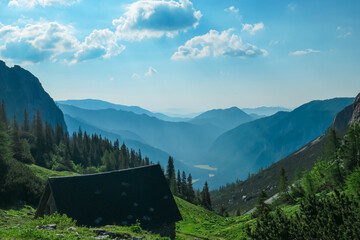 Idyllic alpine meadow of Hauslalm with scenic view of Muerztal valley, Hochschwab mountains, Styria, Austria. Wanderlust in wilderness of Austrian Alps, Europe. Hiking trail in Obersteiermark, summer - obrazy, fototapety, plakaty