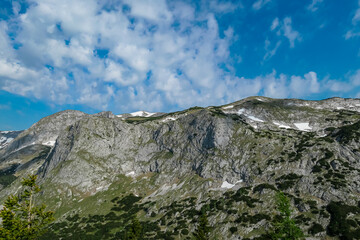 Fototapeta na wymiar Panoramic view of alpine landscape seen from Allakogel, Hochschwab mountains, Styria, Austria. Wanderlust in wilderness of Austrian Alps, Europe. Looking at summit Oehler and Hinterer Polster