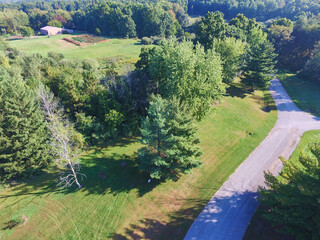 Aerial View of Serene Rural Landscape with Red Barn and Garden Path
