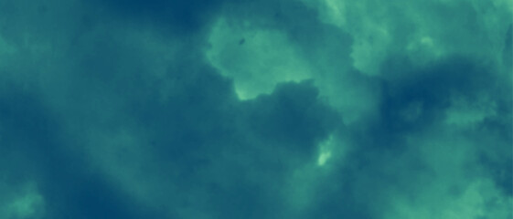 Obraz premium Colorful dark blue watercolor background. Blue cloud background. Blue sky with clouds and sun. Blue and green background.