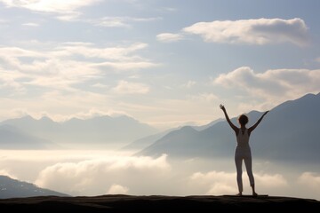Woman in yoga pose standing on a mountain peak, copy space background wallpaper