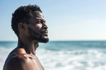 Handsome african american man posing on the beach. Summer time