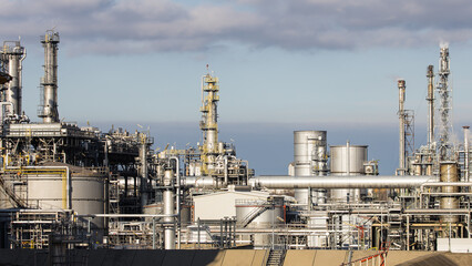 Industrial refinery complex with lots of pipes and smokestacks