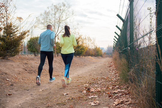 A Man and a Woman Running in a Park