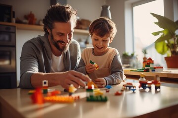 Naklejka premium Family and childhood concept. A boy and a man play with legos. Father and son with a constructor. Dad and child build with plastic cubes