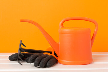 Orange gardening tools on wooden table