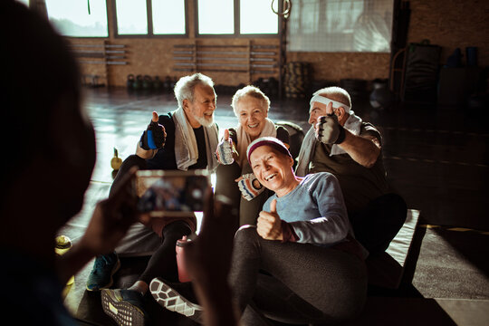 Diverse senior people taking a group photo in gym
