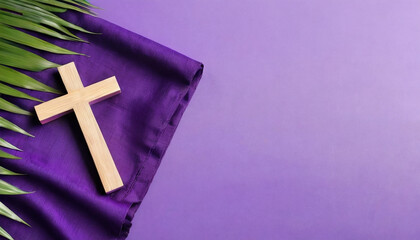 Wooden cross with Bible, palm leaf and purple cloth on color background. Good Friday concept