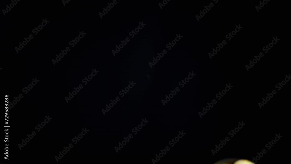 Poster colorful soap bubbles fly in an empty space on isolated black background. many rainbow transparent b