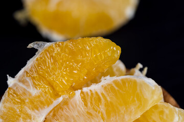 peeled slices of ripe and juicy orange close-up