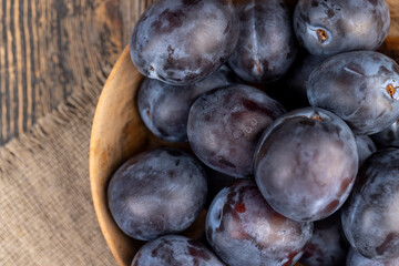 Wet purple plum on the table, fresh harvest