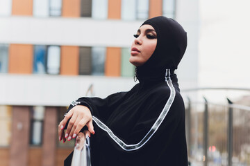 Hijab girl exercising on walkway bridge in early morning. Muslim woman wearing sports clothes doing stretching workout outdoors.