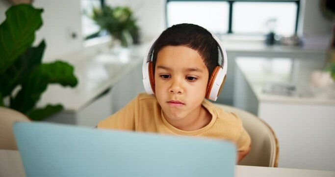 Laptop, home school and headphones for education with boy student in online class for child development. Computer, study or virtual elearning with young kid in apartment for internet assessment