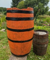 orange old wooden barrel in the rural summer garden. 