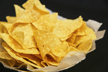 Crispy Golden Tortilla Chips Close-Up on Black Background
