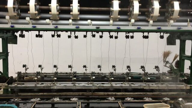 Silk factory in China processing and harvesting silk from silkworm cocoons