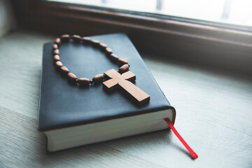 a cross and a bible on a table