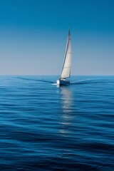 Fototapeta premium A solitary sailboat with its sails unfurled glides across the expansive blue ocean, leaving a frothy trail in its wake, embodying freedom and adventure