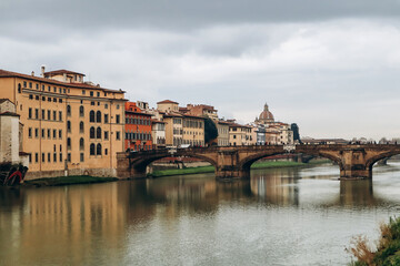 Fototapeta na wymiar The Ponte Vecchio, a medieval stone closed-spandrel segmental arch bridge over the Arno, in Florence, Italy